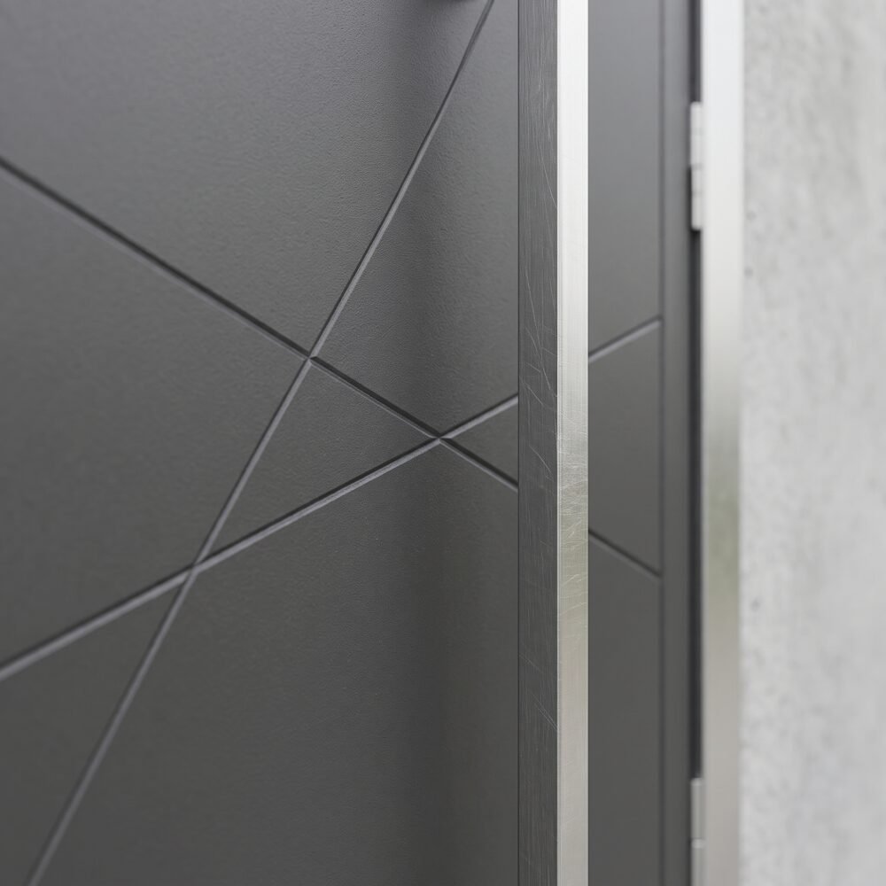 Double heighted modern gray architectural entry door with geometric diagonal detailing and long vertical handle