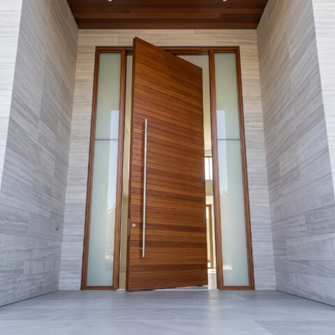Luxury wooden Pivot Door Double Heighted Door with horizontal detailing and glass sidelights by Tarkhan Door