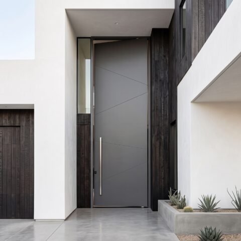 Modern matte gray Pivot Door Double Heighted Door with geometric detailing and glass sidelights by Tarkhan Door