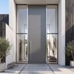 Modern matte gray Pivot Door Double Heighted Door with geometric detailing and glass sidelights by Tarkhan Door