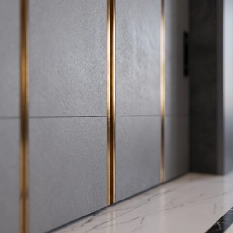 Tarkhan Door double heighted white pivot door with vertical gold accents and minimalist handle in a modern luxury interior