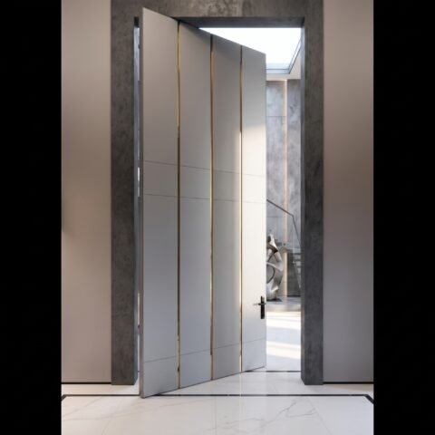 Tarkhan Door double heighted white pivot door with vertical gold accents and minimalist handle in a modern luxury interior