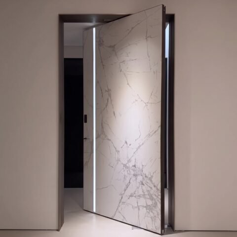 Tarkhan Door Double Hieghted Door with white marble finish, gray veining, vertical metallic accent and dark frame
