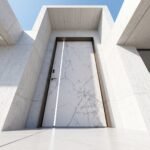 Tarkhan Door Double Hieghted Door with white marble finish, gray veining, vertical metallic accent and dark frame